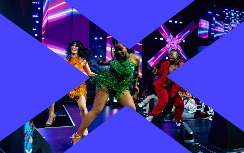 Dancers on the Fusion Fest stage, including a performer in a green sequined outfit